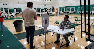 Poll workers checking voters into a Wisconsin polling site in 2020