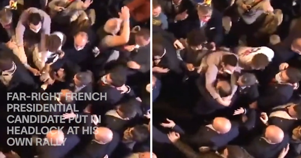 French presidential candidate Eric Zemmour being wrapped in a headlock in the middle of a large crowd