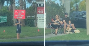 Video of child holding a sign shaming him for being a bully and parents sitting nearby