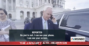 Senator Ron Johnson pretending to be on the phone outside of the Capitol