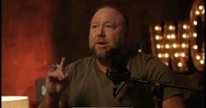 Alex Jones holding up a finger while speaking on Louder with Crowder