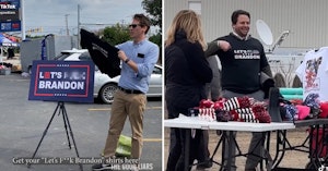 Jason Selvig and Davram Stiefler selling and wearing t-shirts reading "Let's F--- Brandon"