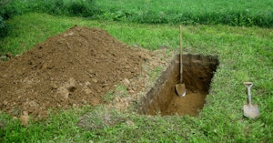 A single grave dug in a field